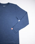 Front flat-lay view of the MOVE Sport Apparel Men’s Essential Long Sleeve in Blue Mirage with one sleeve folded across the shirt.