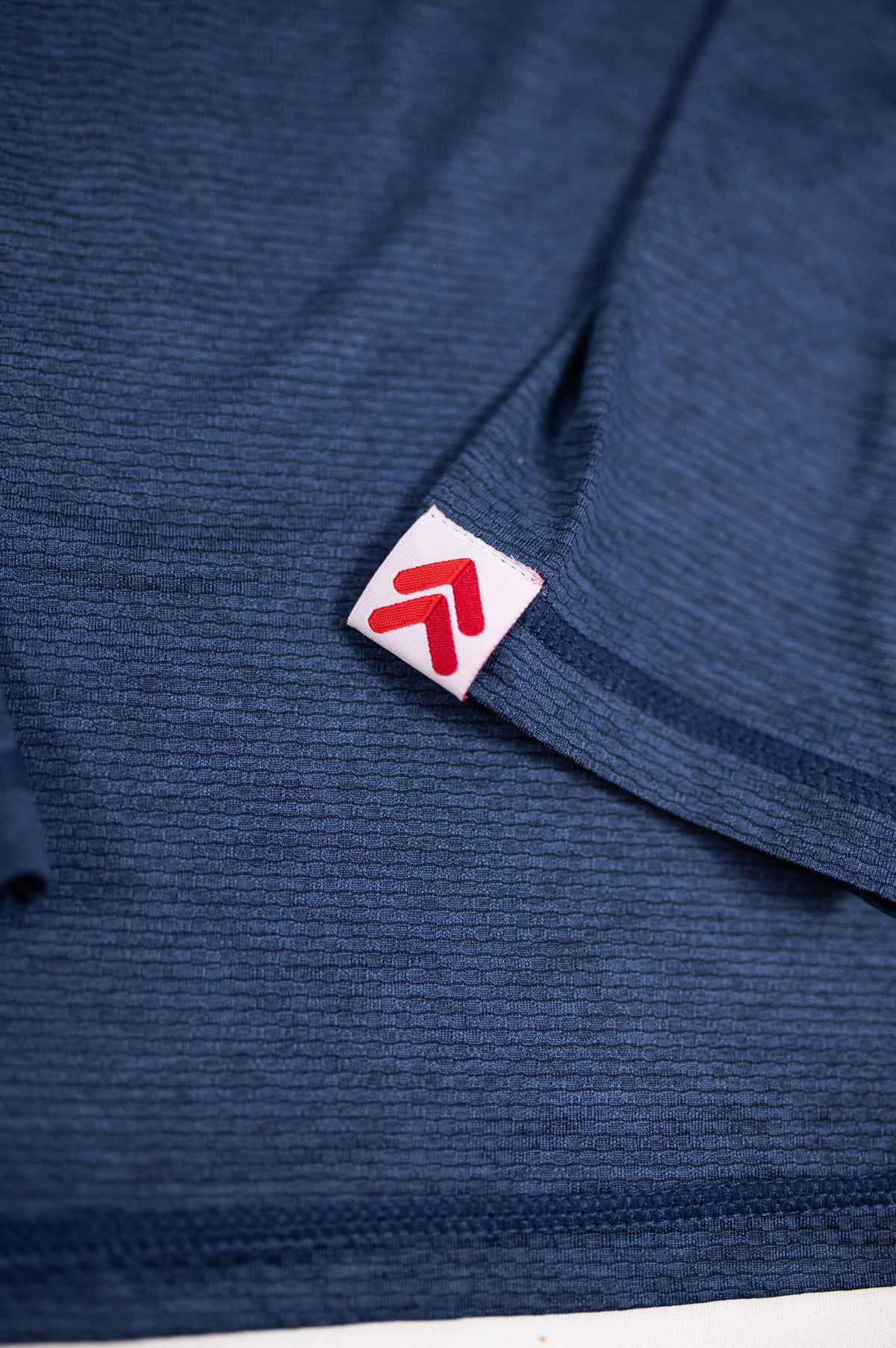 Close-up of the original sleeve tab and textured Naval academy fabric on the men’s LuxDry long sleeve.