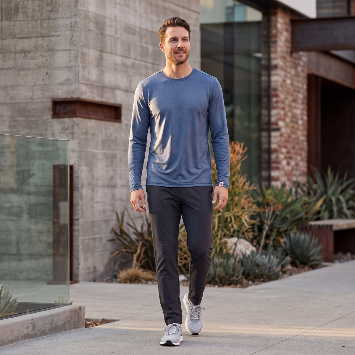 Man wearing MOVE Sport Apparel men’s LuxDry long sleeve in Naval academy on a city sidewalk.