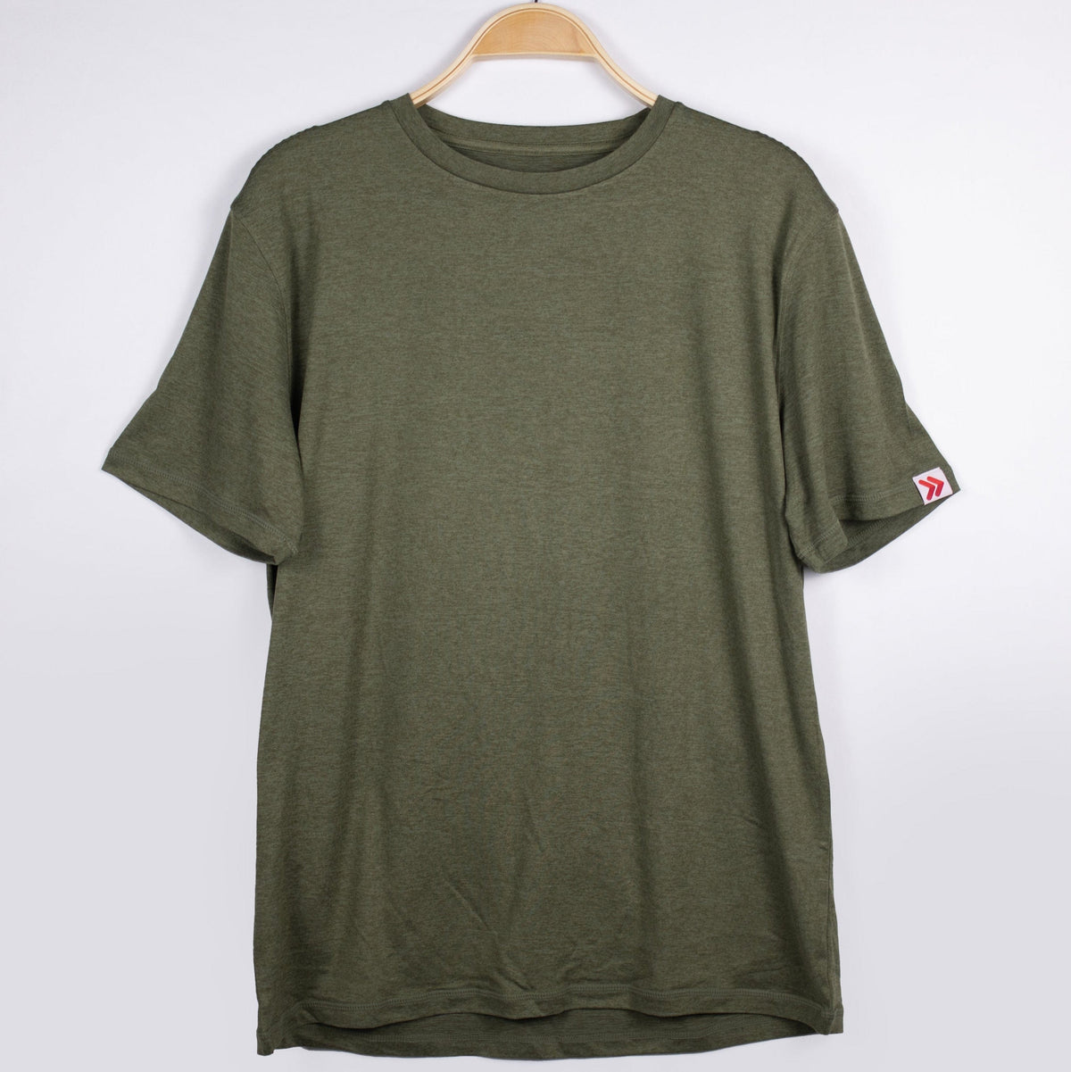 MOVE Sport Apparel men’s Essential Short Sleeve: Heather Hunter Green shirt shown from the front on a hanger.
