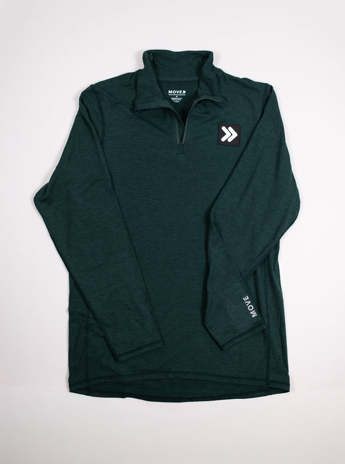 MOVE Sport Apparel Men’s Essential Quarter Zip in Pine Grove laid flat, showing the original chest patch and sleeve lettering.