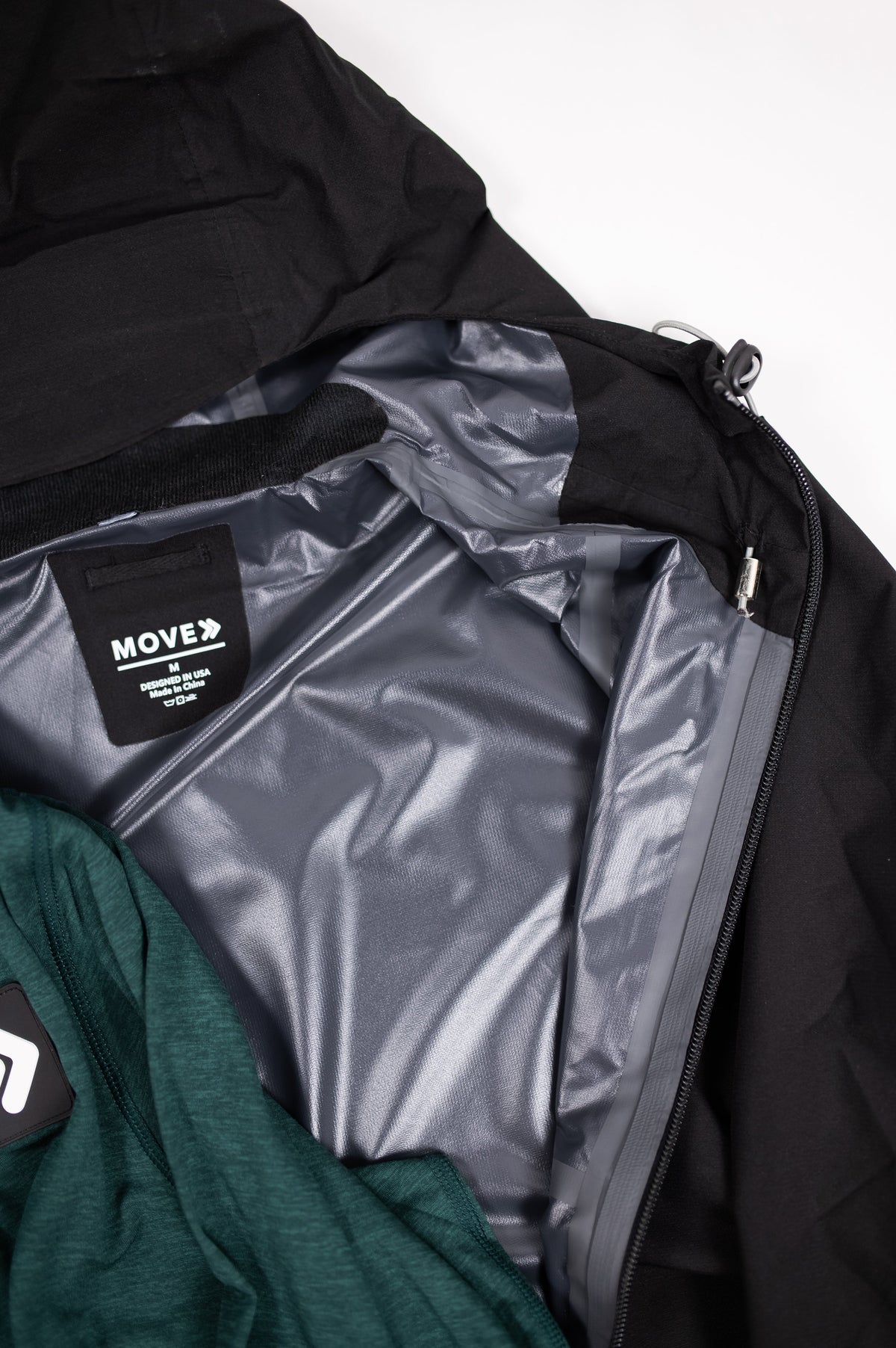Close view of a MOVE Sport Apparel quarter zip and jacket layered neckline.