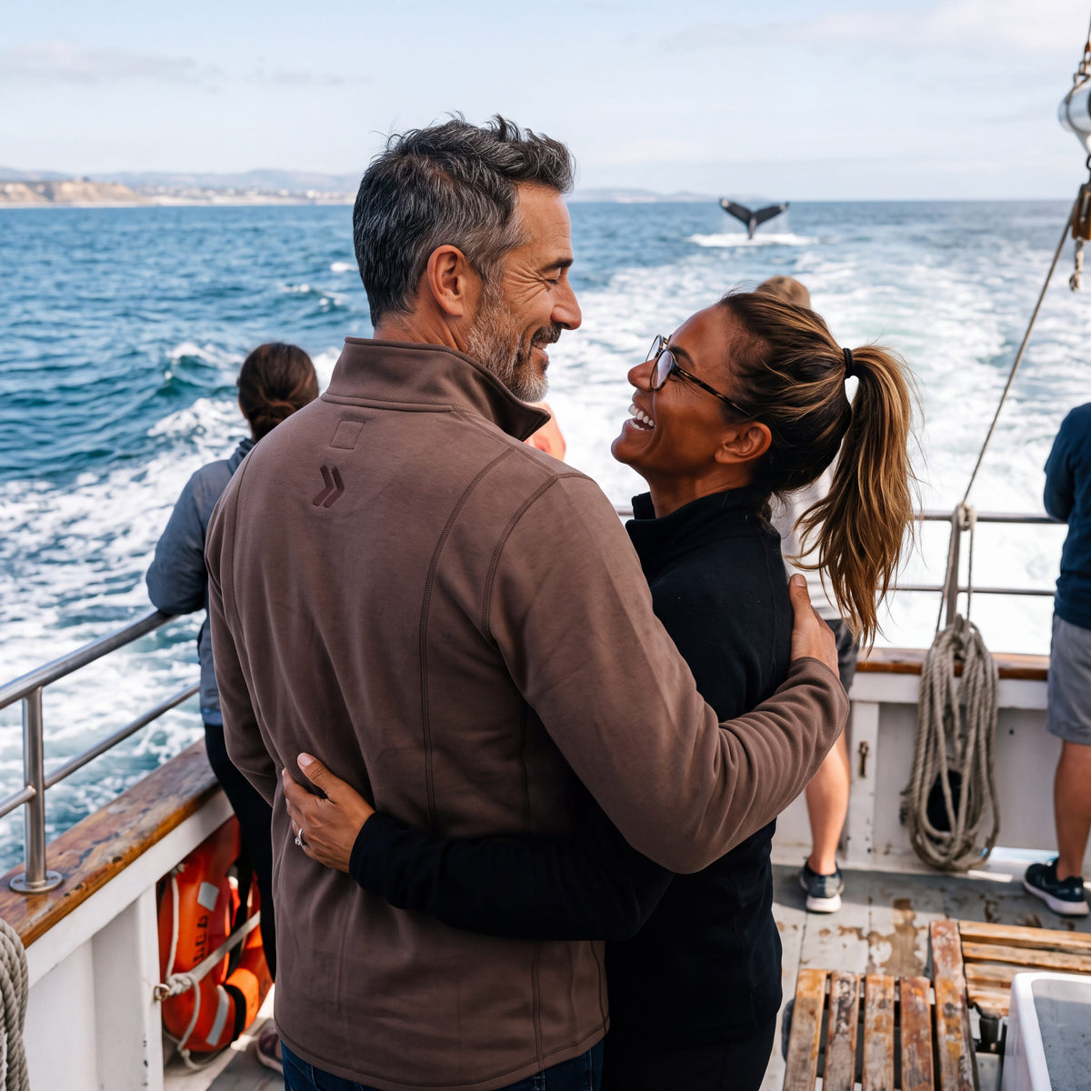 Man wearing the MOVE Sport Apparel men’s Performance Quarter Zip Pullover in Coffee Quartz on a boat.