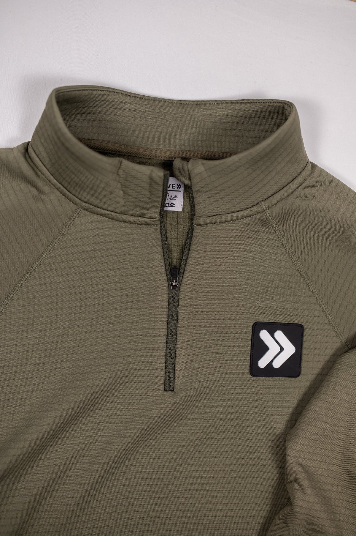 Close view of the Smokey Olive MOVE Sport Apparel waffle quarter zip collar, quarter zipper and original chest patch.