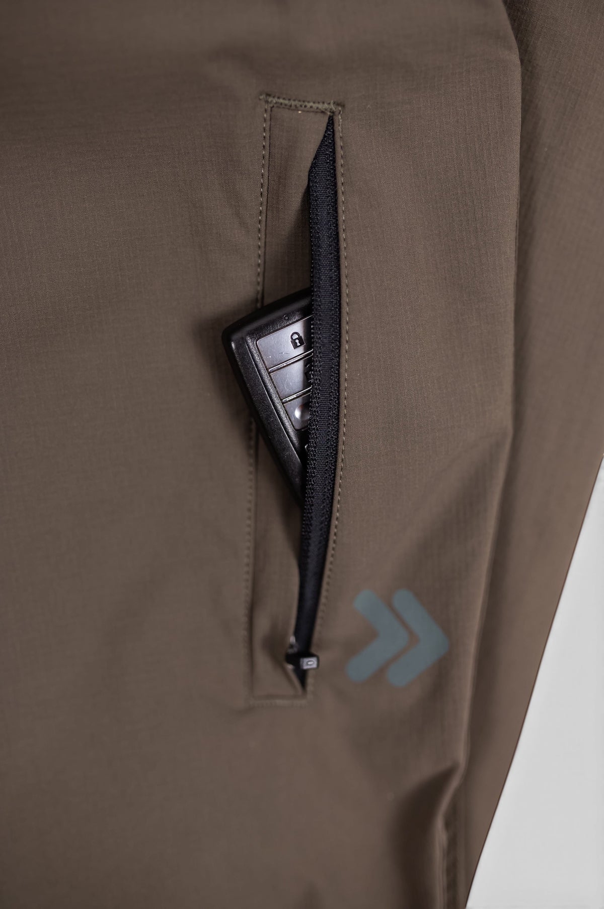 MOVE sport apparel men's olive green ripstop joggers featuring a zippered pocket with a car key inside