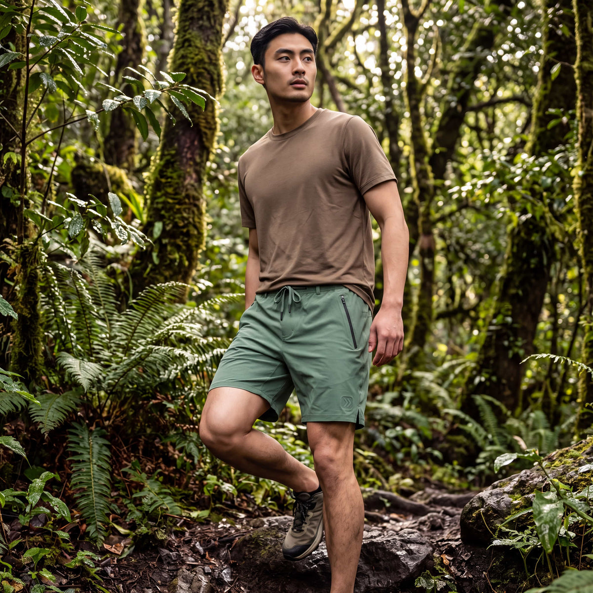Man wearing MOVE Sport Apparel men’s Ripstop Shorts in Comfrey on a forest trail.
