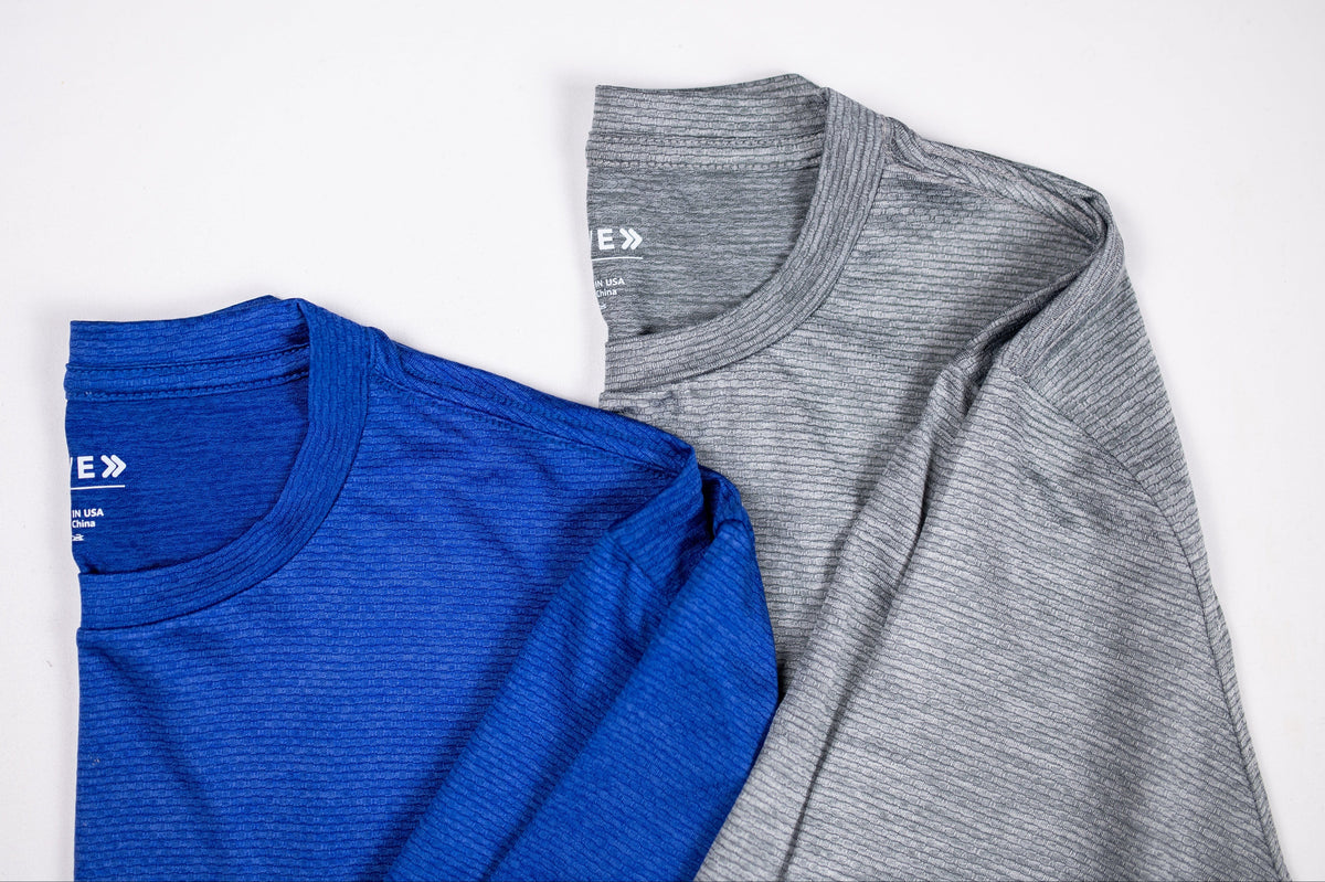 Blue and grey LuxDry tee necklines and fine fabric shown together.