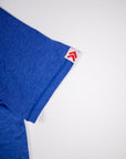 Surf the Web blue LuxDry tee sleeve hem showing original white tab and red double chevrons.