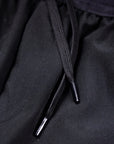 Close-up of black MOVE sport apparel Agility training shorts featuring perforated fabric and a drawstring waist.
