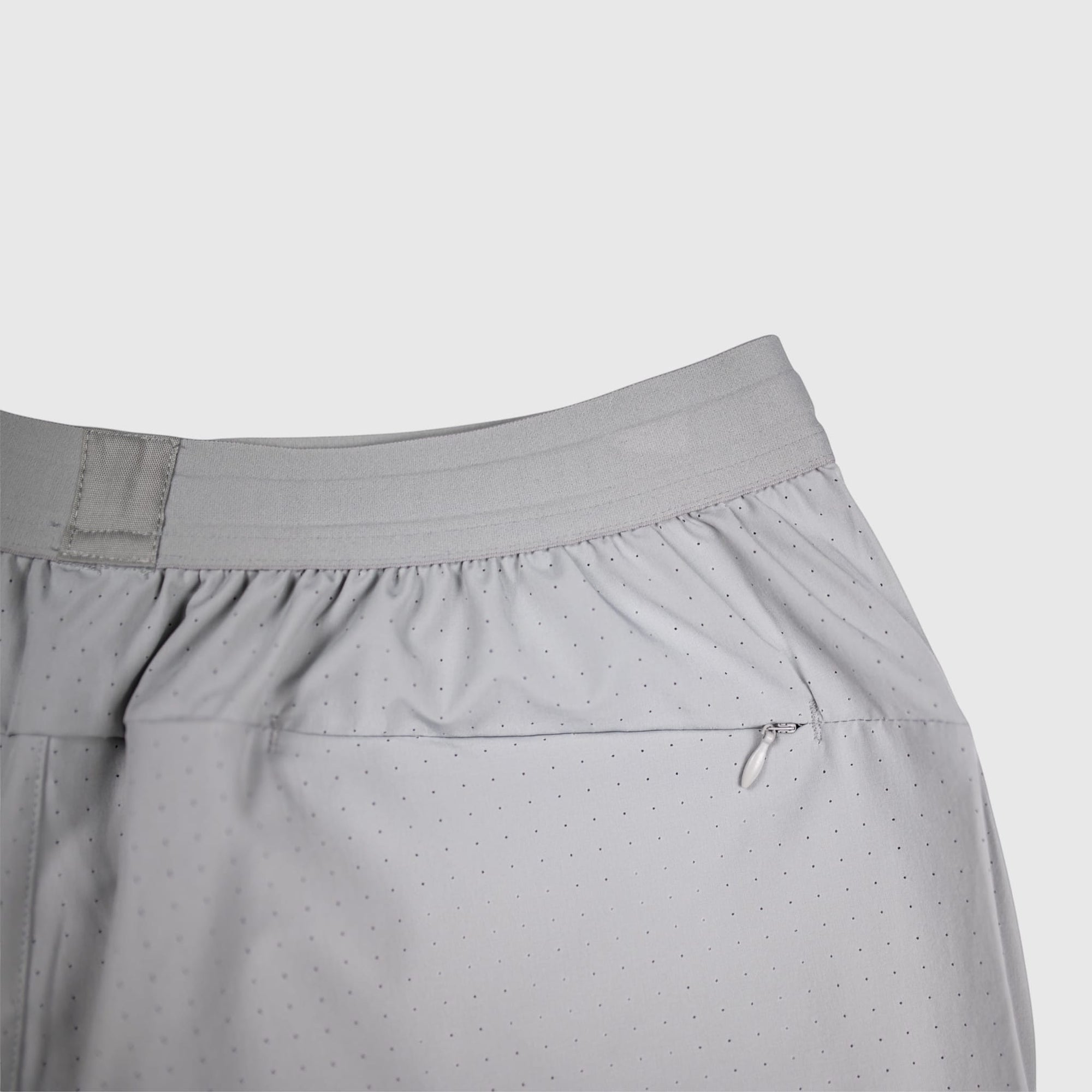MOVE sport apparel grey perforated training shorts with an elastic waistband and a small zippered back pocket