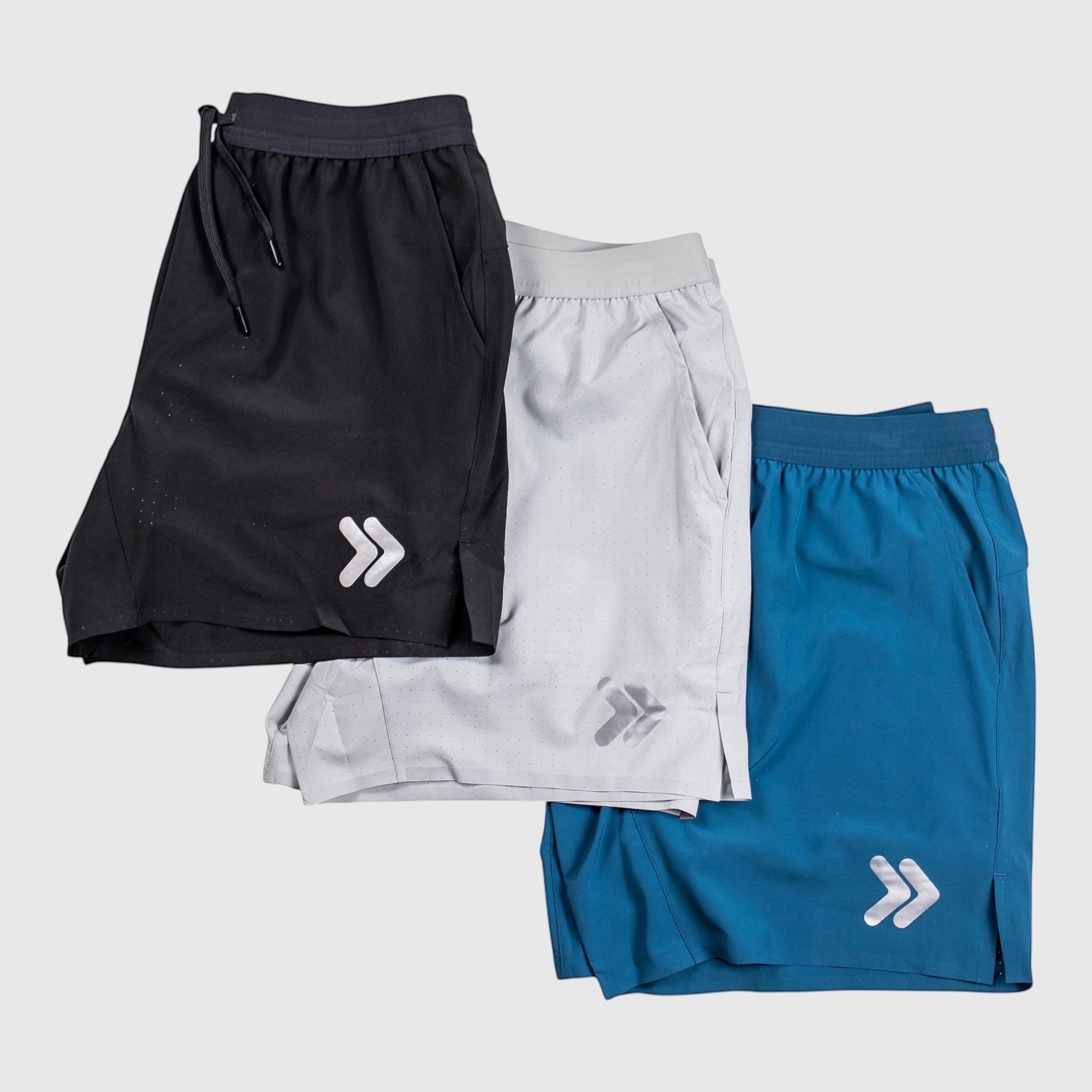MOVE sport apparel Agility 6 inch training shorts in black, light grey, and blue with reflective logo and side vents