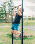 MOVE sport apparel Agility 6 inch training shorts in blue worn by a man doing pull-ups on an outdoor bar
