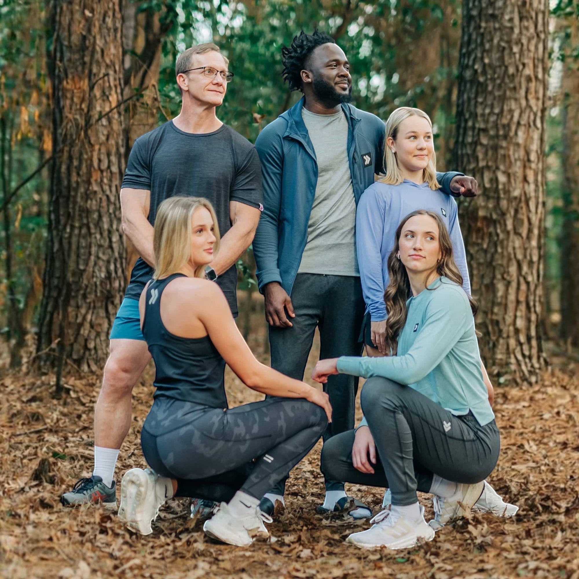 MOVE sport apparel group wearing athletic training gear and shorts in a forest setting