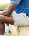 MOVE sport apparel Agility 6 inch training shorts in light grey with a built-in boxer brief liner on a male athlete