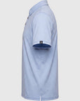 Side view of a light blue MOVE sport apparel Essential Polo Shirt in moisture-wicking fabric with a sleeve logo tab.