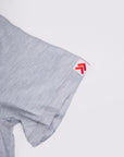 MOVE sport apparel Essential Polo Shirt sleeve in heather grey moisture-wicking fabric with red logo tag detail