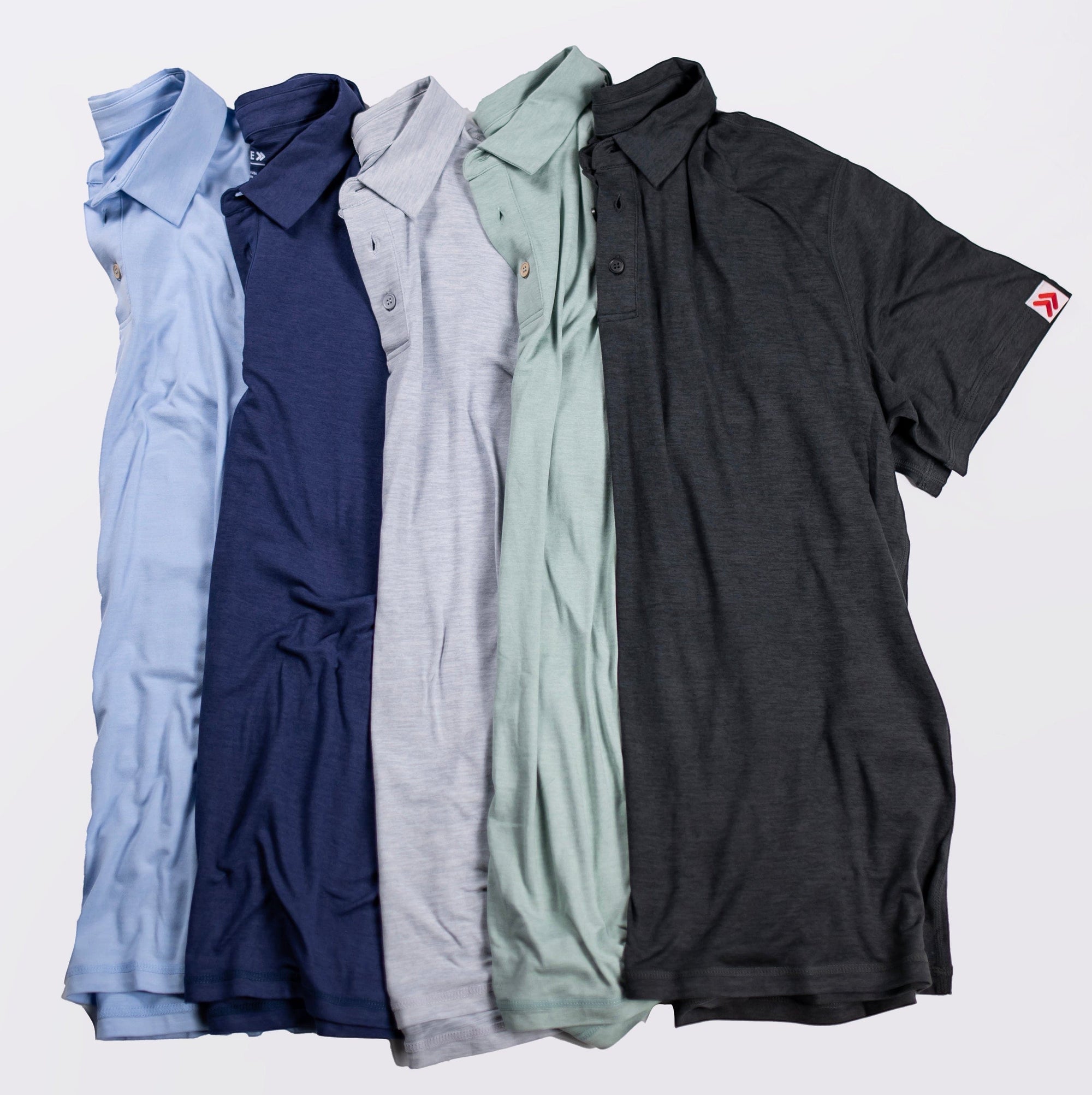MOVE sport apparel Essential Polo Shirts in five different colors made from moisture-wicking performance fabric.