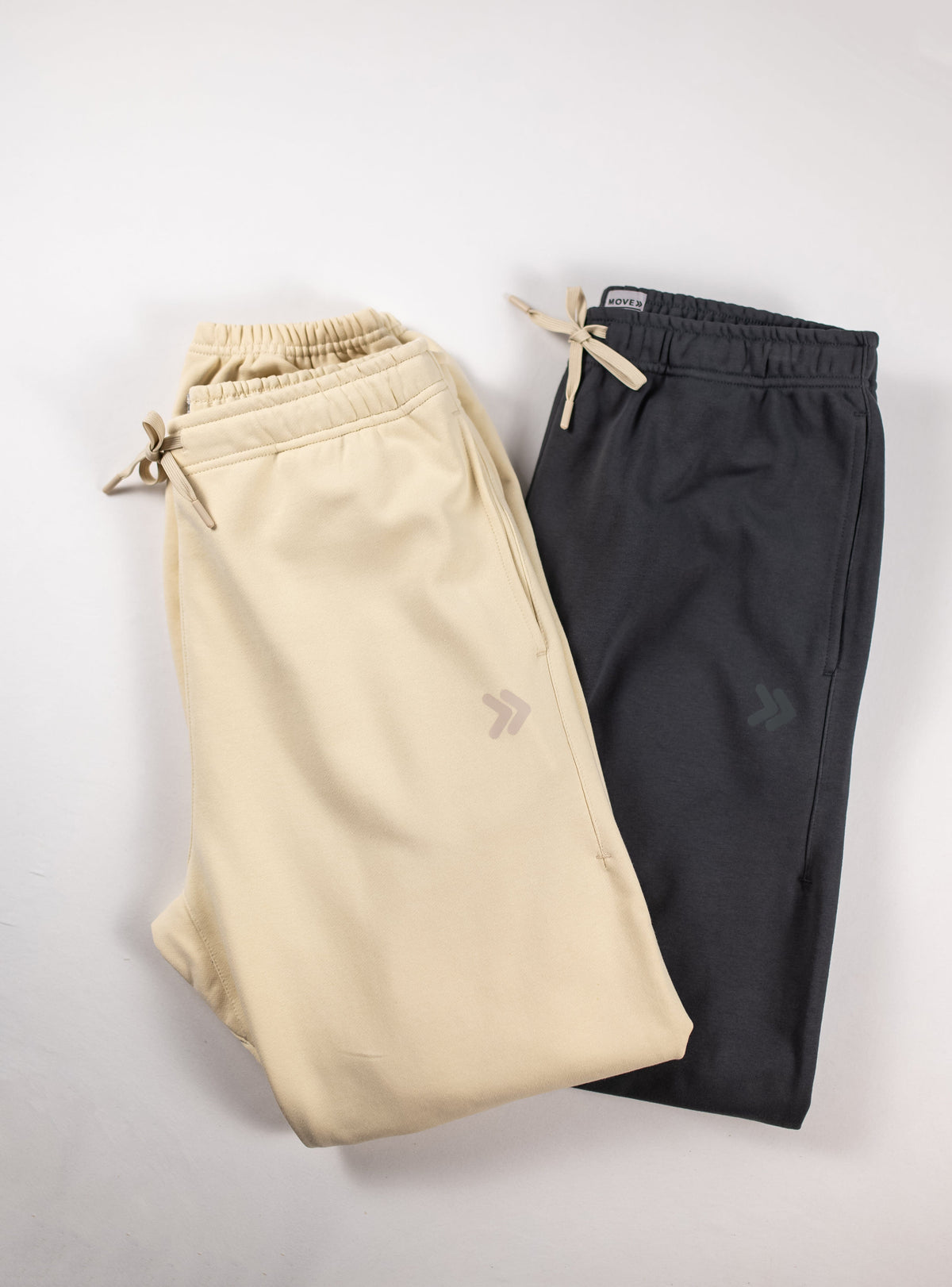 MOVE sport apparel French Terry Joggers in beige and charcoal grey with drawstring waistbands and side pockets.
