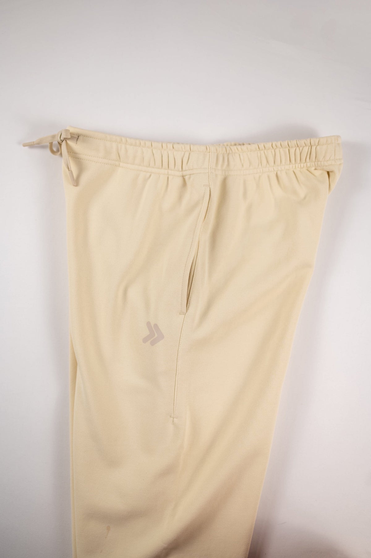MOVE sport apparel beige French terry joggers featuring an elastic drawstring waistband and side pockets.