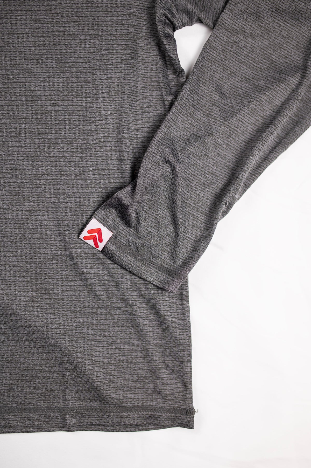 MOVE sport apparel Men's LuxDry long sleeve shirt in charcoal grey with textured fabric and branded sleeve tab