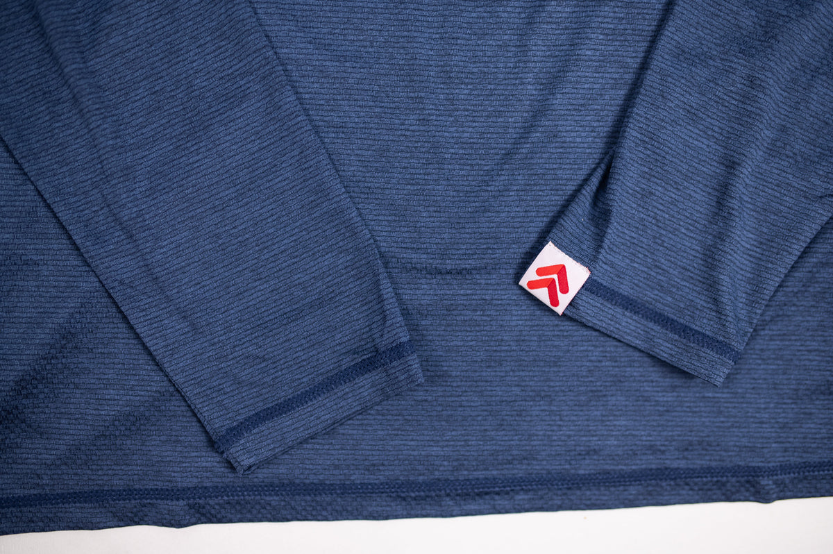 MOVE sport apparel Men's LuxDry long sleeve shirt in blue with textured fabric and signature red logo sleeve tab