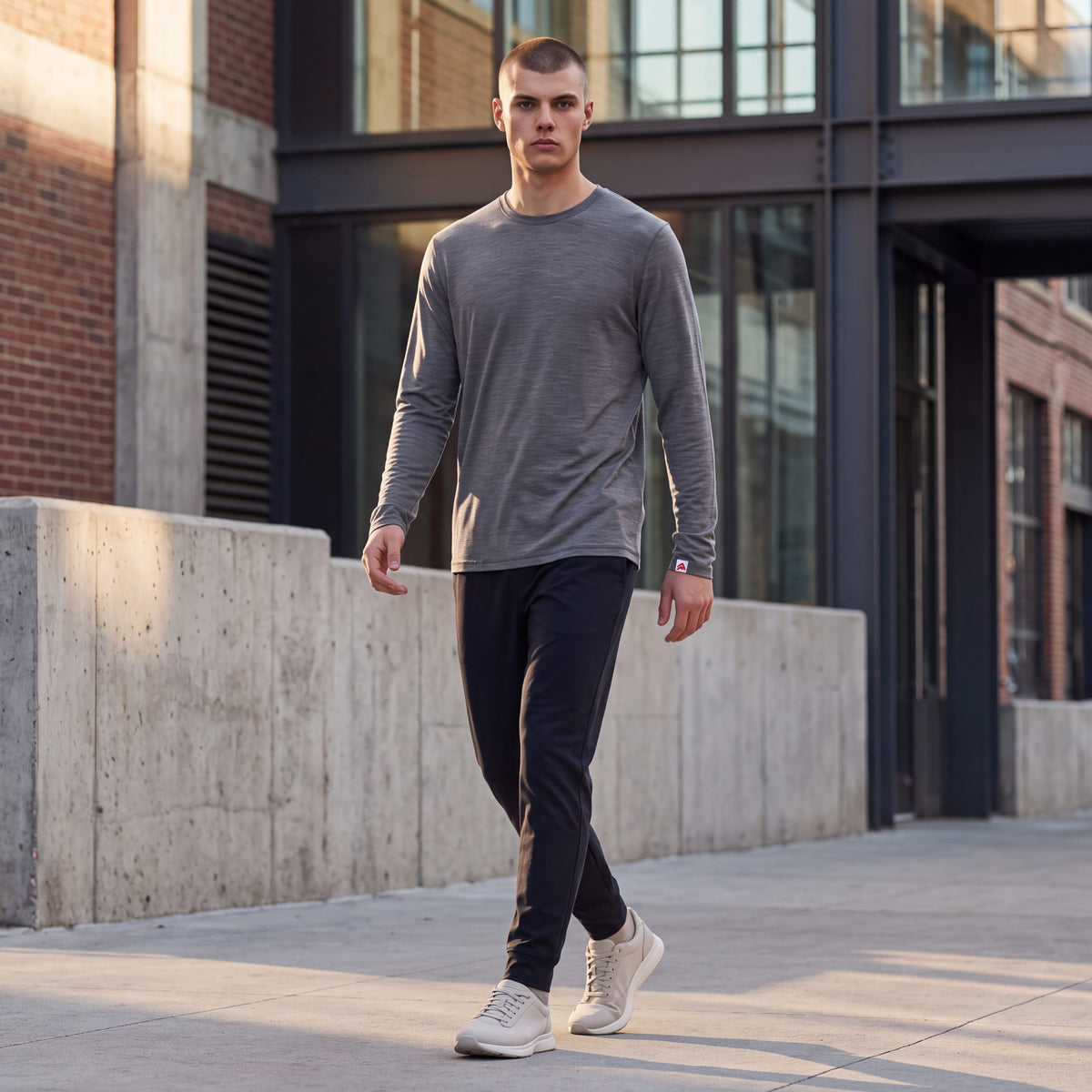 MOVE sport apparel men's heathered grey merino wool long sleeve shirt with crew neck worn by a model in the city