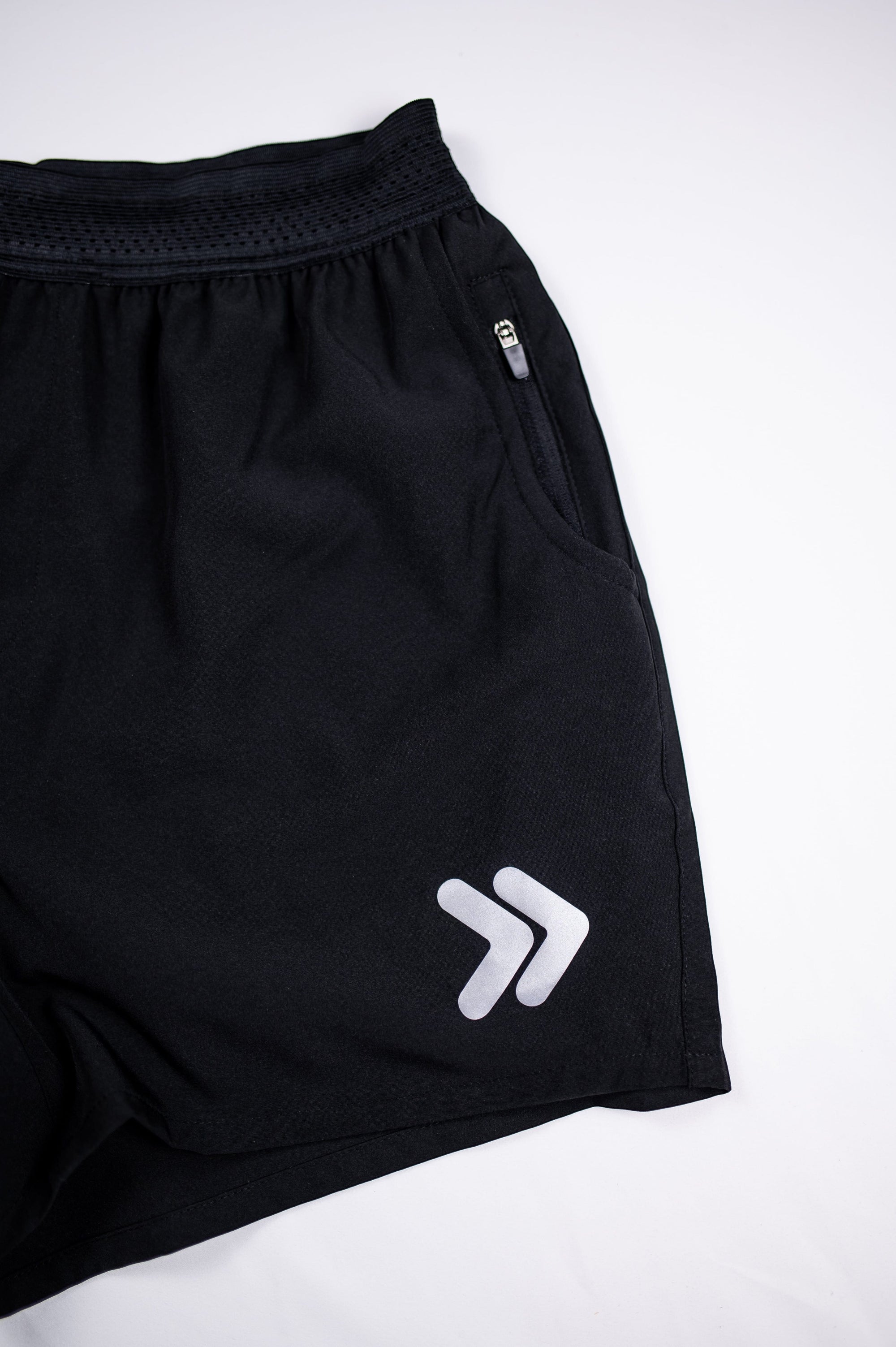 MOVE sport apparel black men's running shorts featuring a breathable waistband, zippered pocket, and reflective logo.
