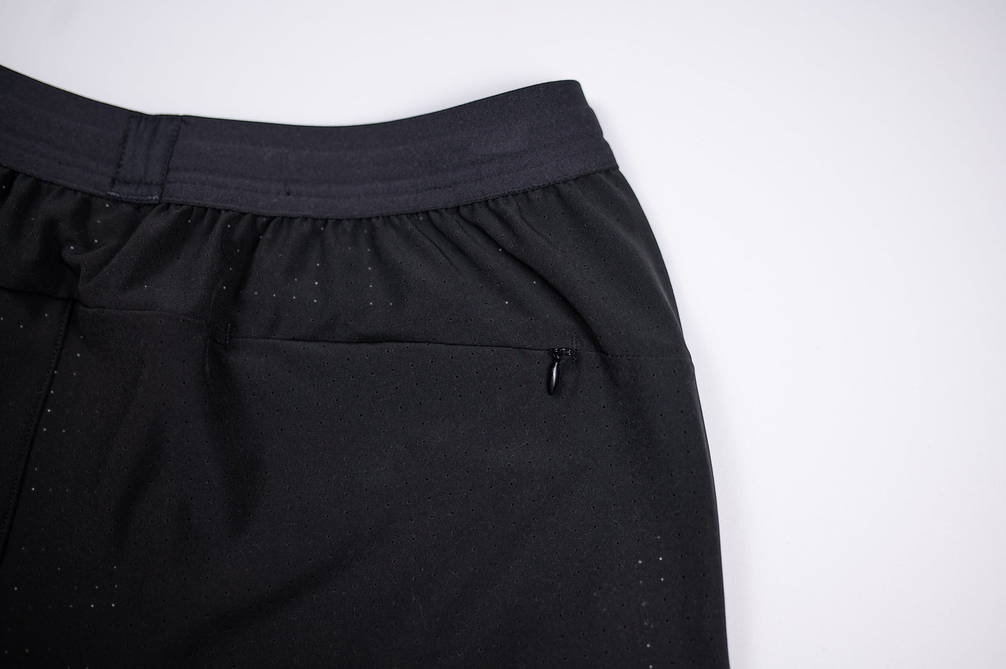 MOVE sport apparel men's black running shorts featuring a breathable waistband and a secure zippered pocket.