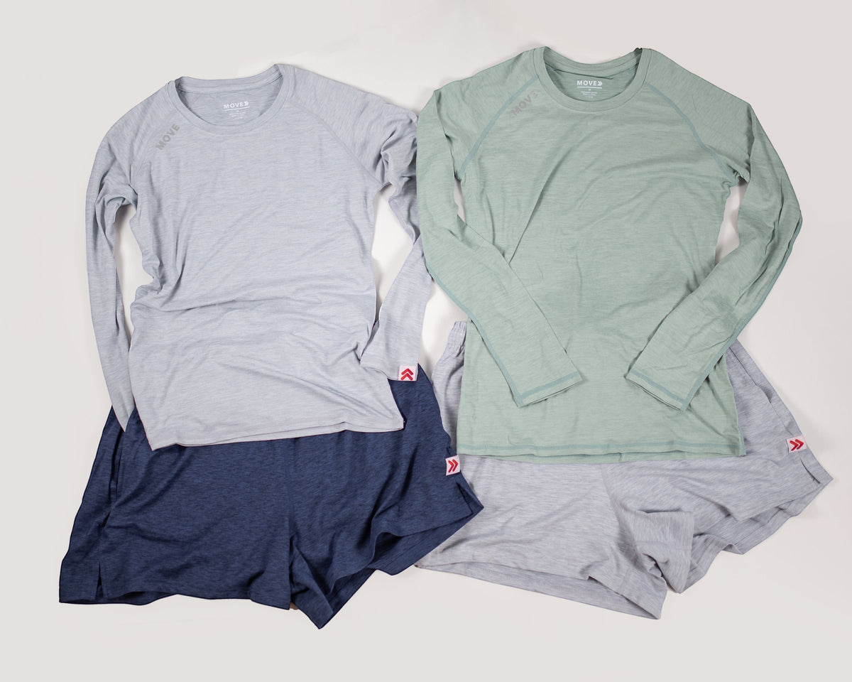MOVE sport apparel long sleeve shirts and athletic shorts in grey, sage green, and navy blue on a neutral background