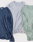 MOVE sport apparel Women's Essential long sleeve shirts in blue, grey, and sage green with subtle logo detailing.
