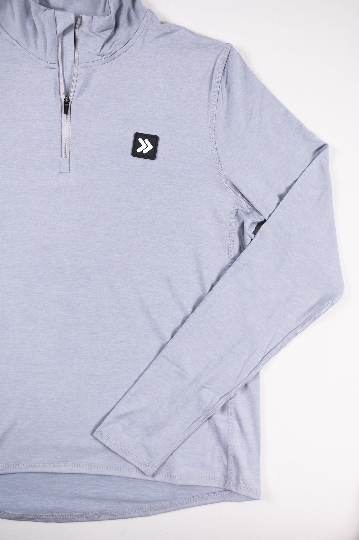 MOVE sport apparel women's light blue quarter zip pullover with a reflective logo patch on the chest.
