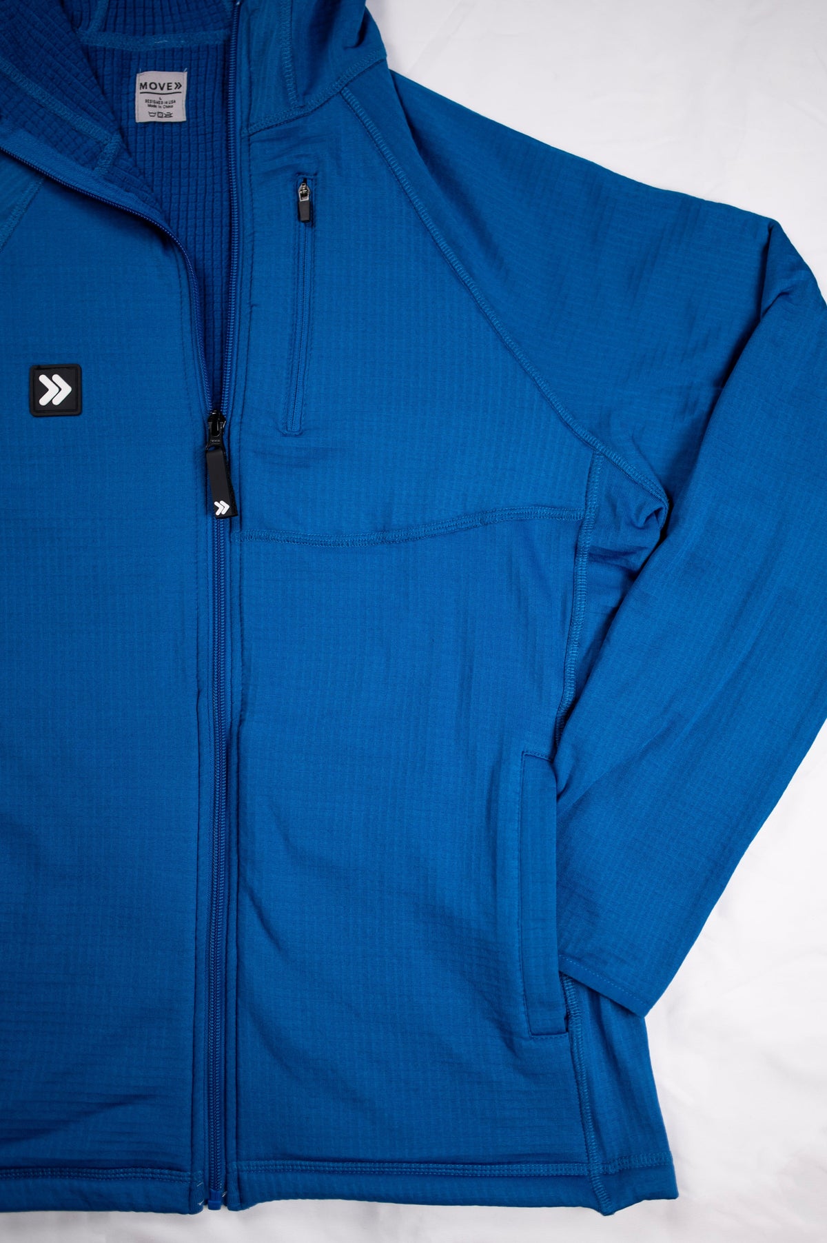 MOVE sport apparel women's blue waffle-knit full-zip hoodie with raglan sleeves and a zippered chest pocket.