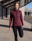 MOVE sport apparel women's burgundy waffle-knit full-zip hoodie with raglan sleeves and chest pocket on a track