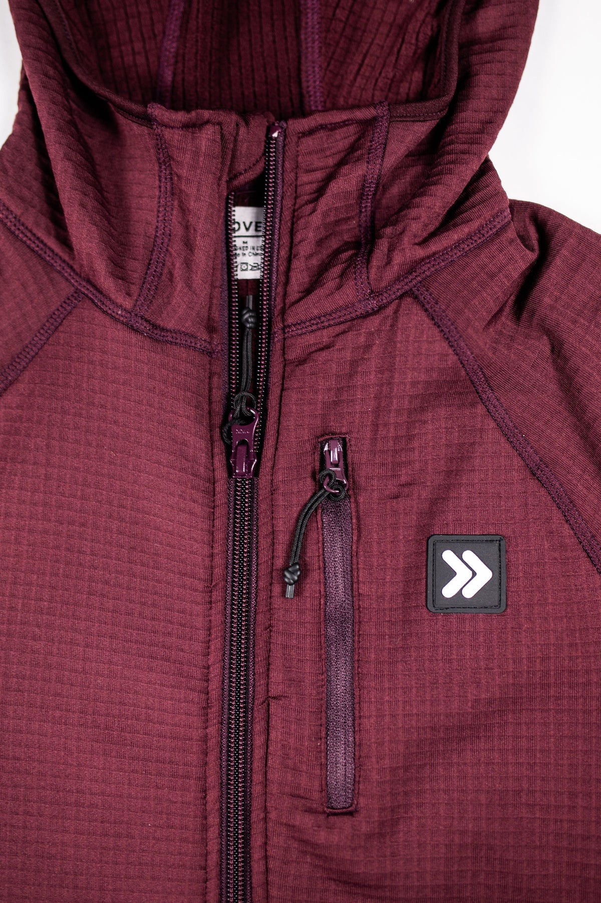 MOVE sport apparel women's burgundy waffle-knit full zip hoodie with a secure zippered chest pocket and raglan sleeves.