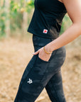 MOVE sport apparel black cropped tank top paired with camo print leggings featuring side pockets for fitness