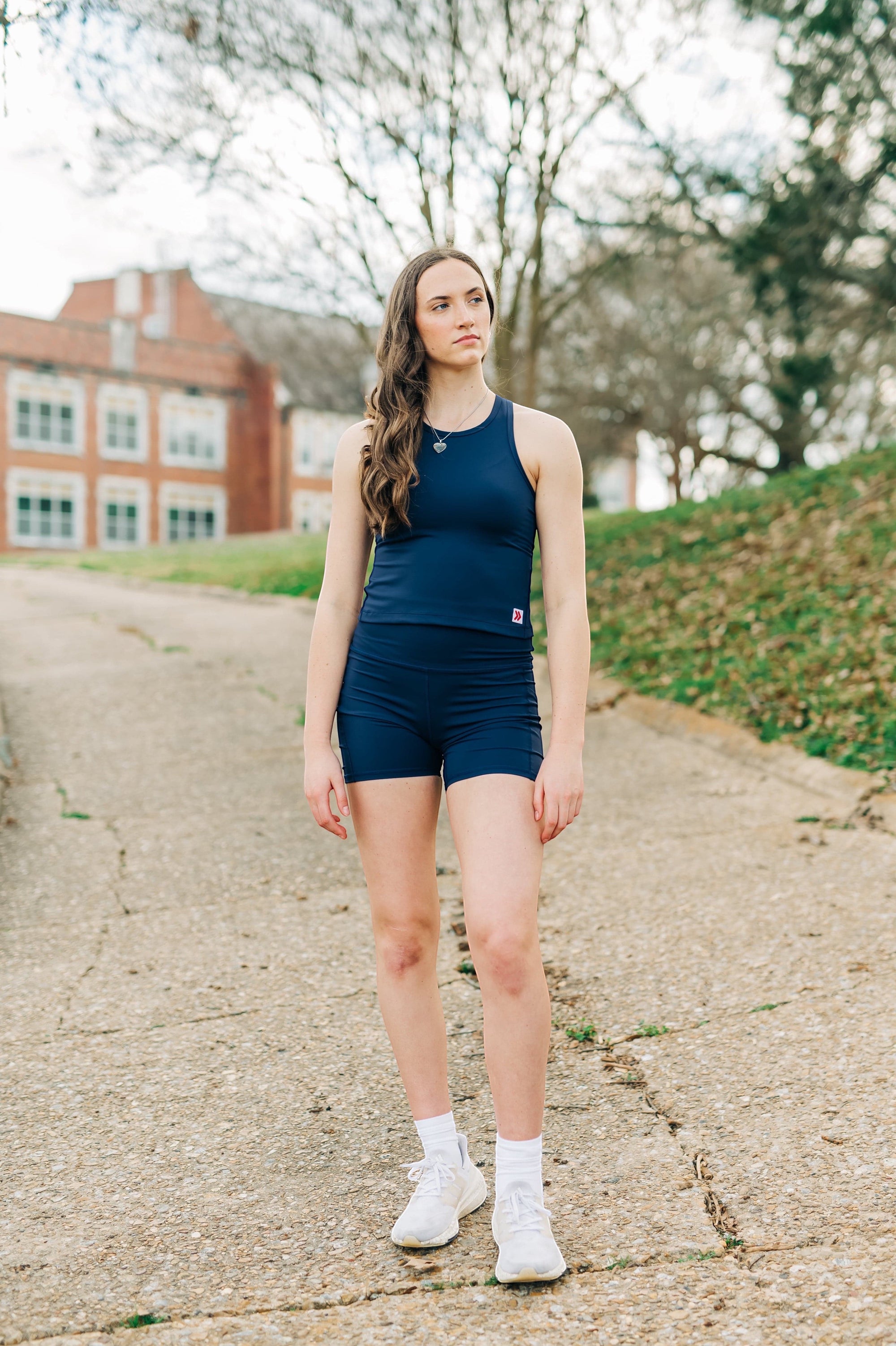 MOVE sport apparel navy blue cropped tank top worn by a woman outdoors for a workout session