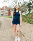 MOVE sport apparel navy blue cropped tank top worn by a woman outdoors for a workout session