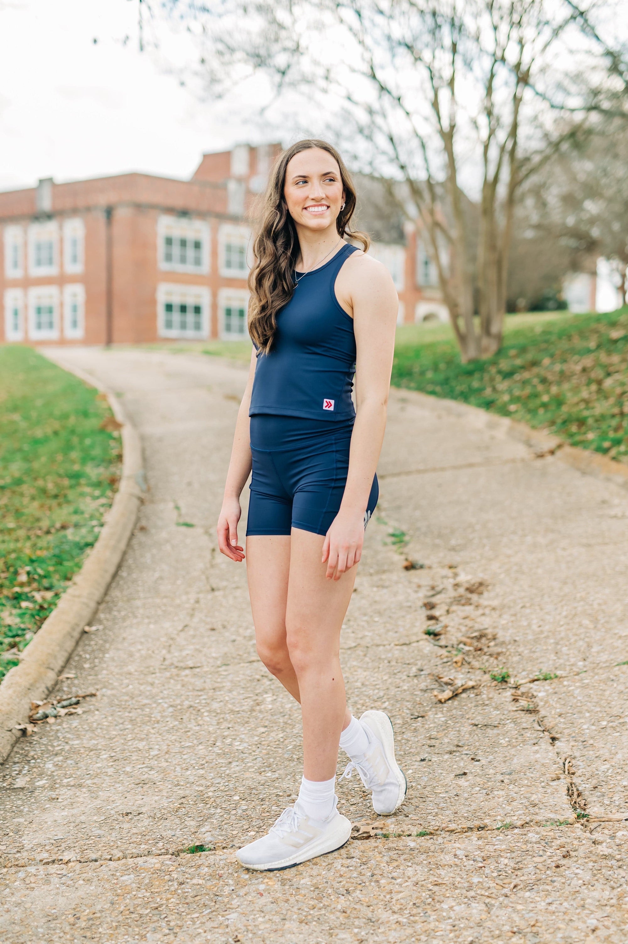 MOVE sport apparel navy blue cropped tank top worn by a woman with matching athletic shorts outdoors