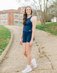 MOVE sport apparel navy blue cropped tank top worn by a woman with matching athletic shorts outdoors