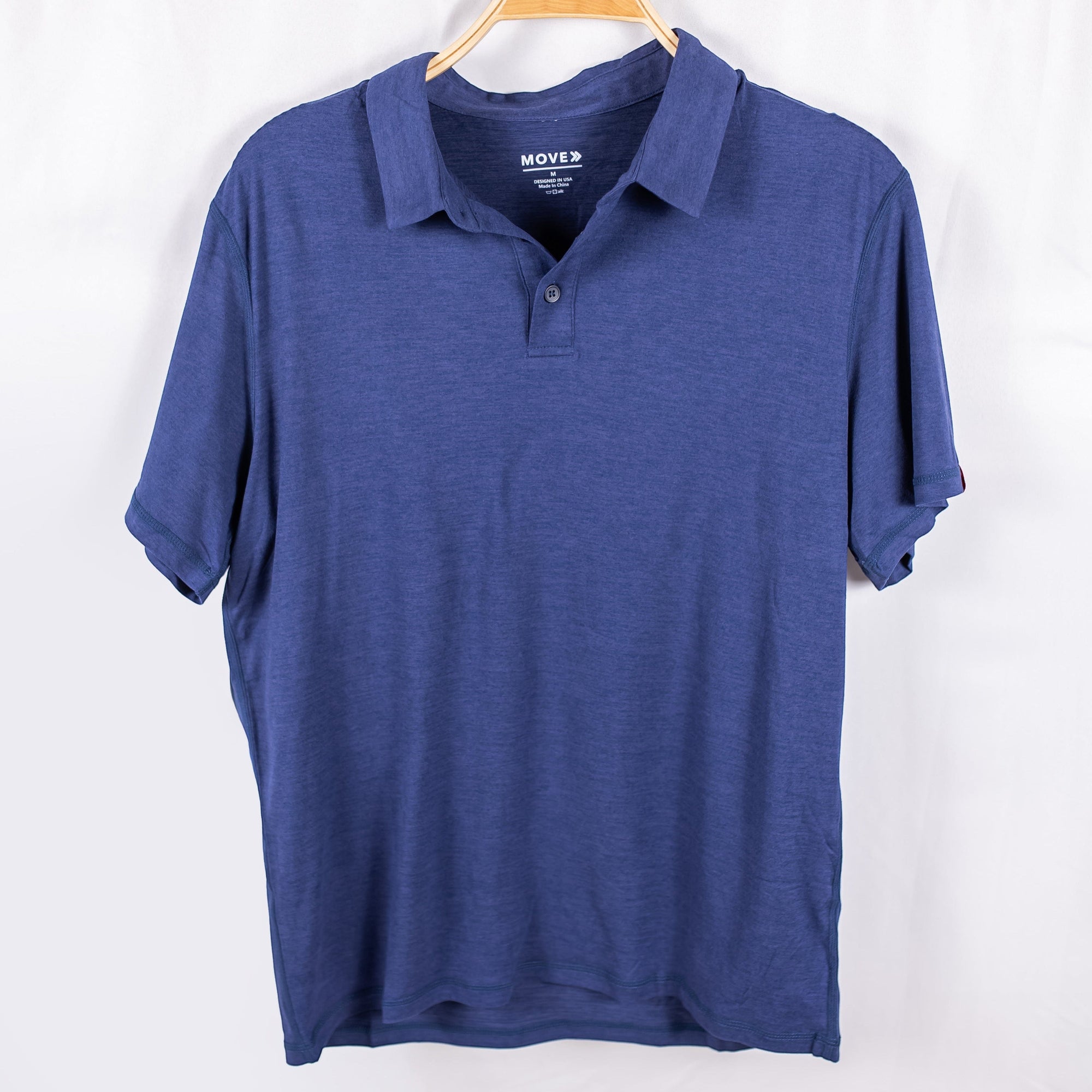 MOVE sport apparel Essential Polo Shirt in blue moisture-wicking fabric with a classic collar and button placket.