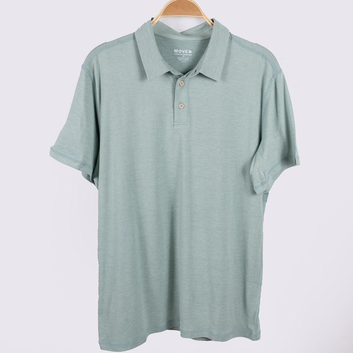 MOVE sport apparel Essential Polo Shirt in sage green moisture-wicking fabric with a classic collar and button placket