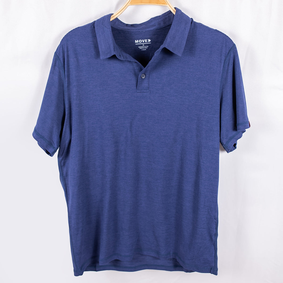 MOVE sport apparel Essential Polo Shirt in blue moisture-wicking fabric with a classic collar and button placket.