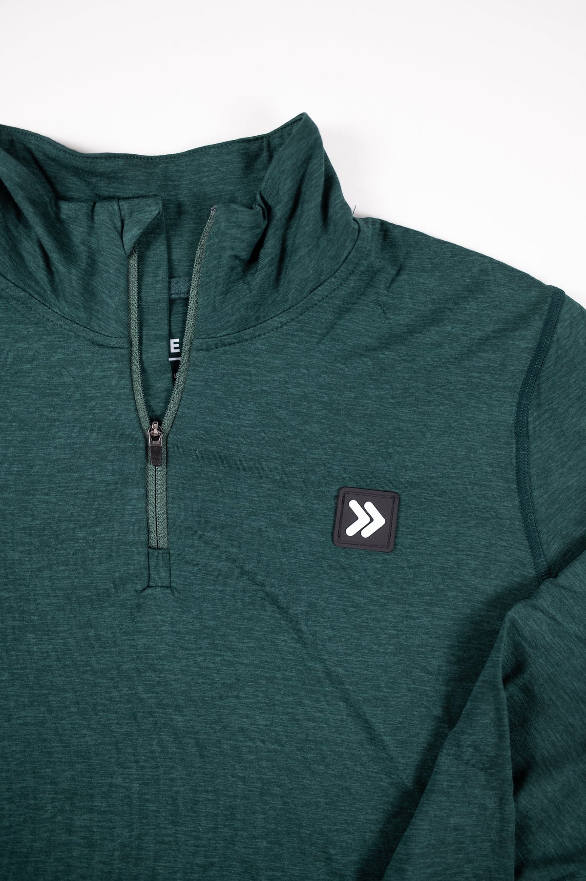 MOVE sport apparel Women's Essential dark green quarter zip pullover with reflective logo patch and zipper detail