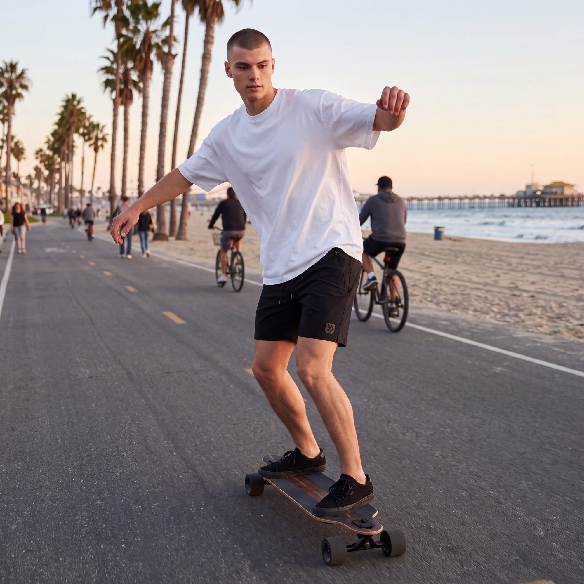 MOVE sport apparel men's black ripstop shorts with 7.5 inch inseam worn by a man longboarding on a beach path