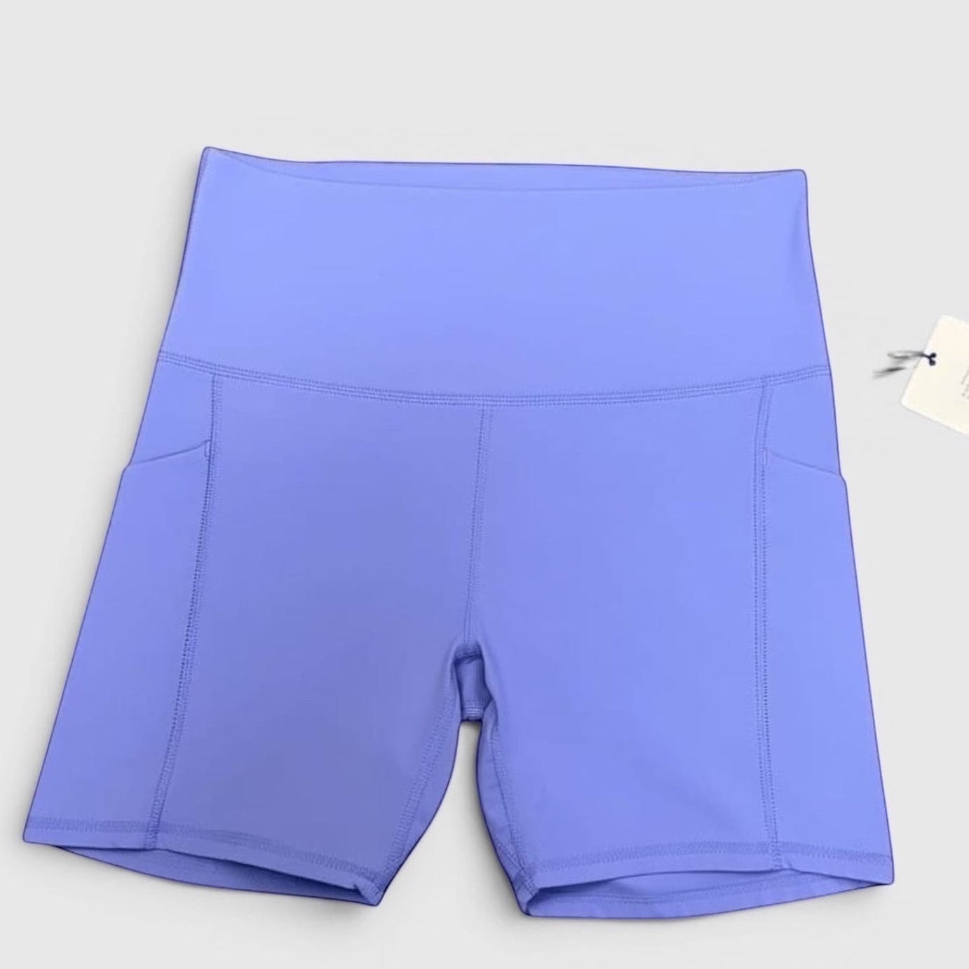 MOVE sport apparel high-rise athletic shorts in periwinkle blue with side pockets and moisture-wicking fabric.
