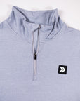 MOVE sport apparel women's light blue quarter zip pullover with a high collar and reflective logo patch.