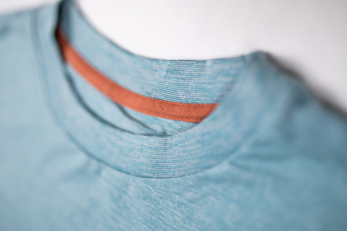 MOVE sport apparel heathered blue crewneck sweatshirt with a contrasting orange inner neck trim