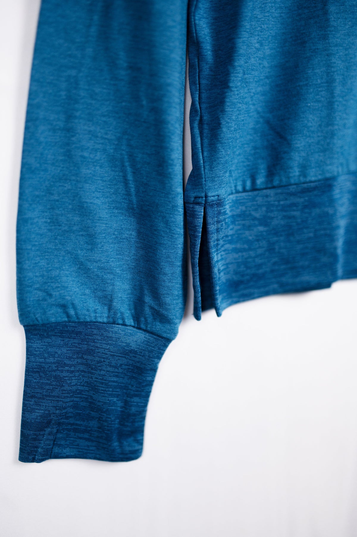 MOVE sport apparel blue heathered long sleeve crewneck sweatshirt featuring ribbed cuffs and a side-slit hem detail.