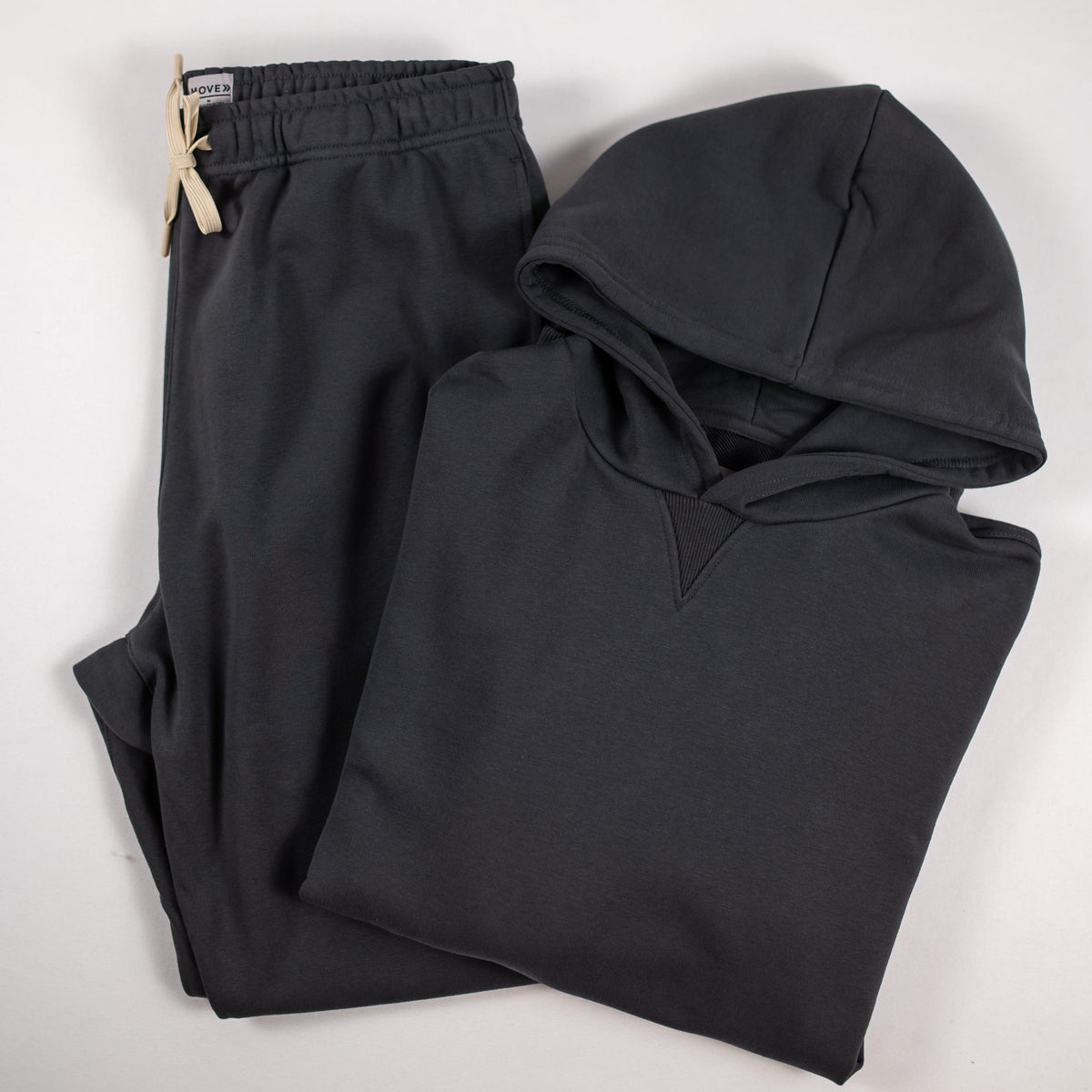 MOVE Sport Apparel French Terry Joggers in Volcanic Ash styled with a matching hoodie in a flat lay.