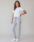 Woman modeling MOVE Sport Apparel Women’s Essential Jogger Black Label in Silver Cloud in a neutral studio.
